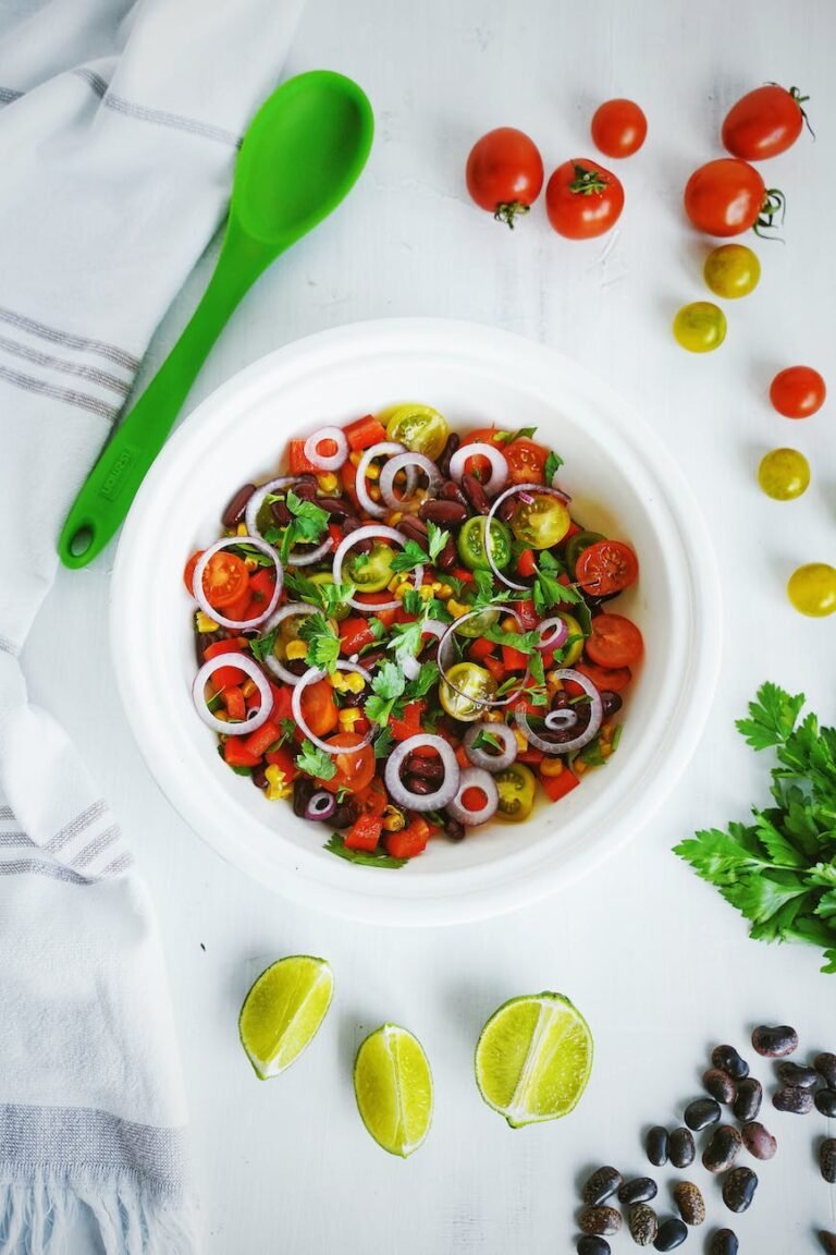 a bowl of garden salad on a white surface