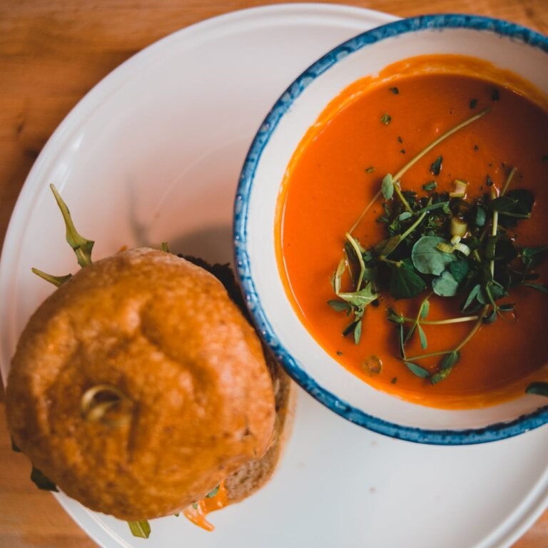 crispy hamburger and bright tomato soup in cafe